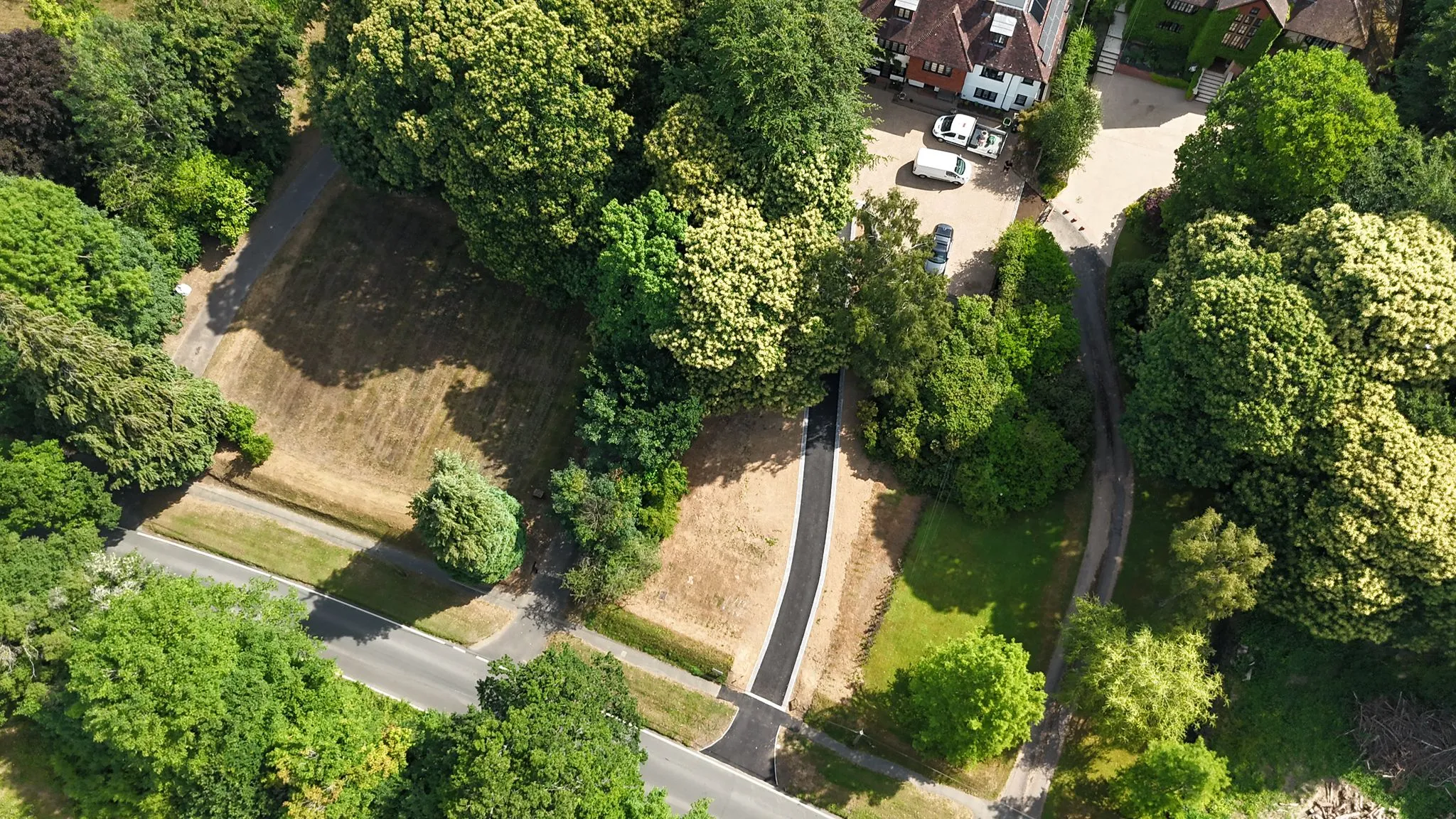 An aerial view of a road surrounded by trees.