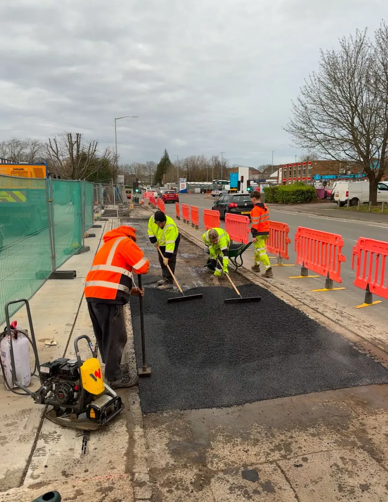 Men tarmacking near a road