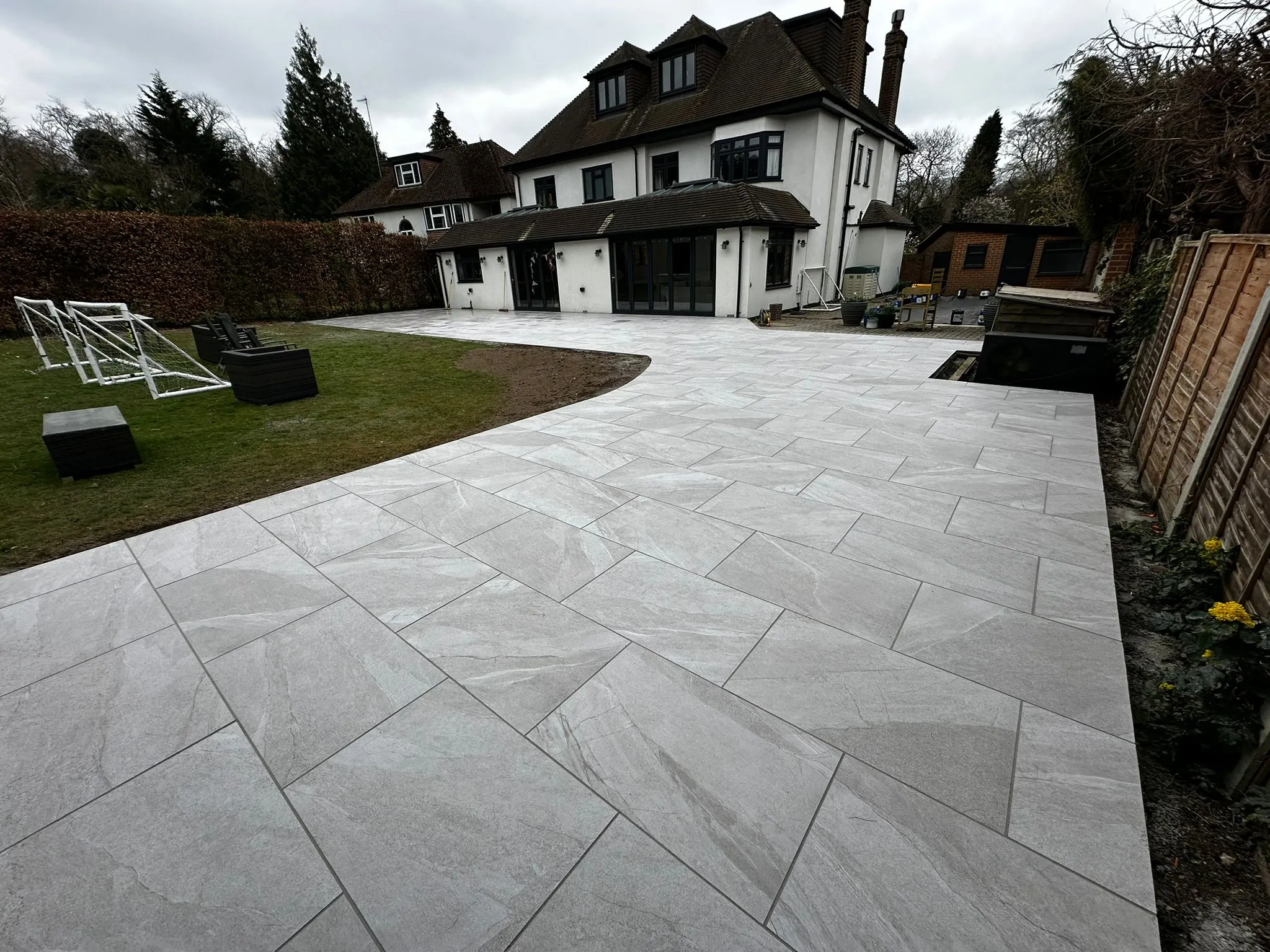 A house with a large patio and a lawn.